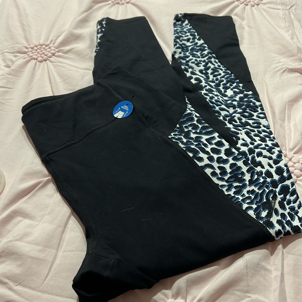 Sketcher leggings with blue and black animal print that goes down the leg.